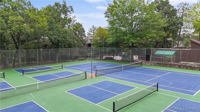 view of tennis court featuring fence