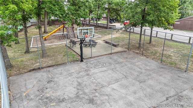 view of sport court featuring a playground