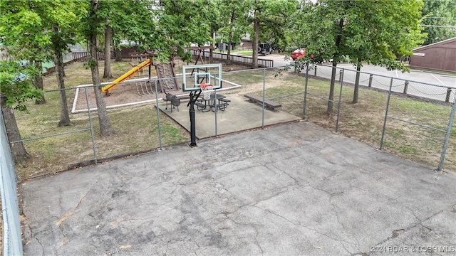 view of patio with fence and a playground