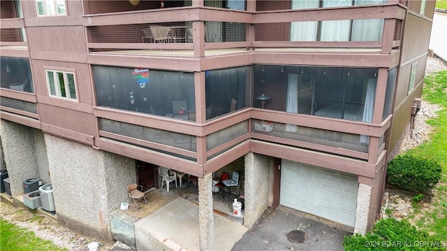 view of property with central AC and an attached garage