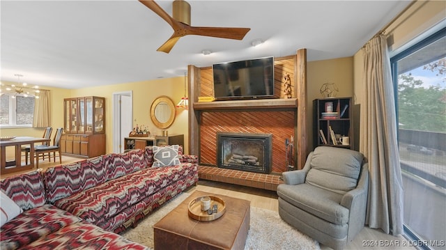 living room with plenty of natural light and ceiling fan with notable chandelier