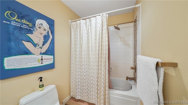 full bathroom with toilet and shower / bathtub combination with curtain