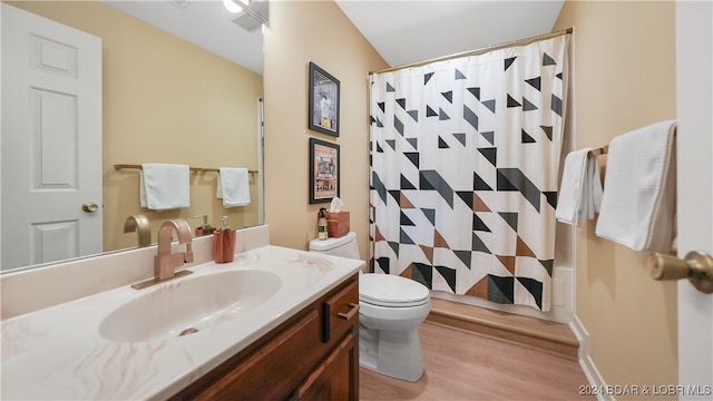 full bathroom featuring vanity, wood-type flooring, toilet, and shower / bathtub combination with curtain