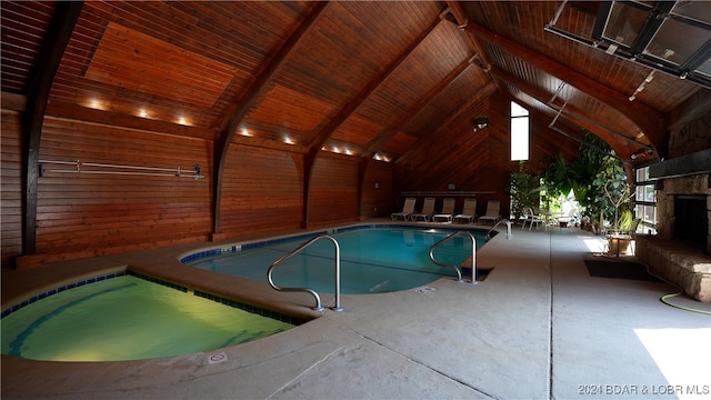 view of pool featuring a patio and a stone fireplace