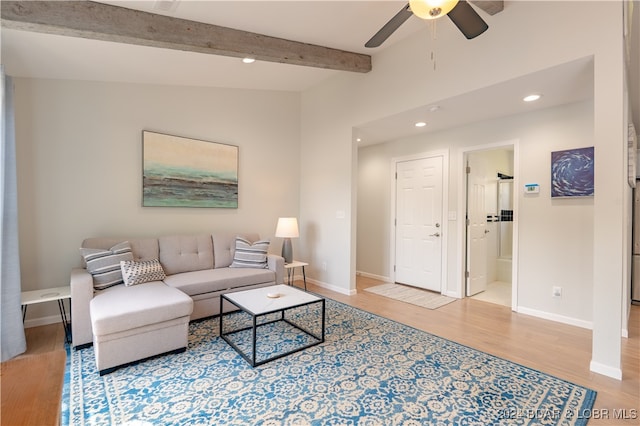 living room with lofted ceiling with beams, light wood-type flooring, and ceiling fan