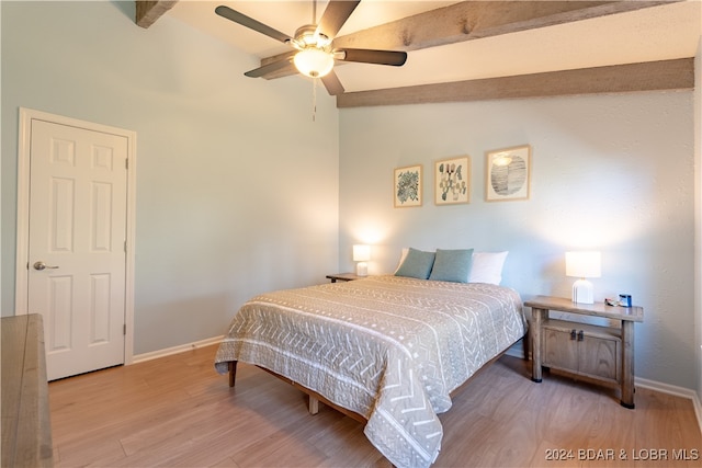 bedroom with lofted ceiling with beams, wood-type flooring, and ceiling fan