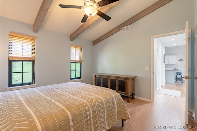 bedroom with ceiling fan, hardwood / wood-style flooring, multiple windows, and lofted ceiling with beams