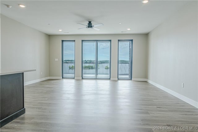 empty room with light wood-style flooring and baseboards