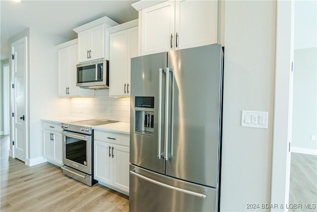 kitchen featuring stainless steel appliances, light wood-style floors, backsplash, light countertops, and white cabinets
