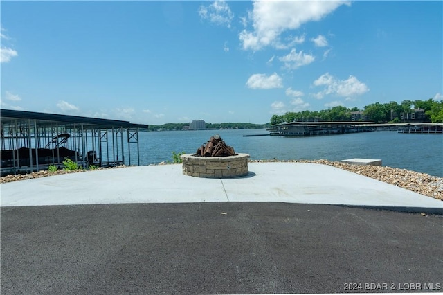 property view of water featuring a fire pit