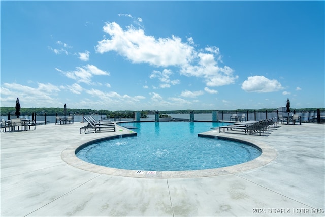 pool featuring fence and a patio