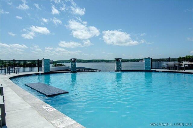 view of pool featuring fence