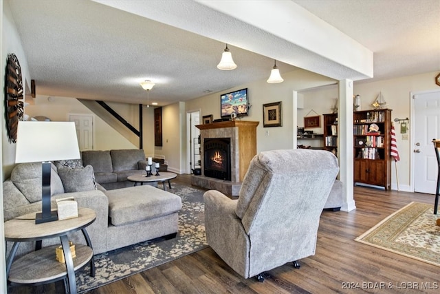 living room with dark wood-type flooring and a textured ceiling