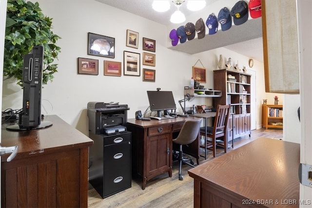 office area with light hardwood / wood-style floors