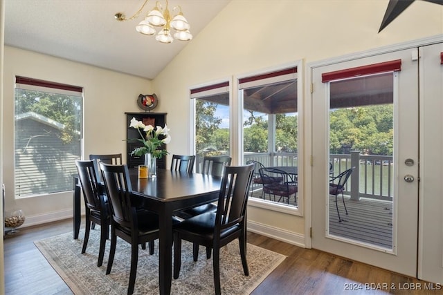 dining space featuring a notable chandelier, lofted ceiling, hardwood / wood-style floors, and a healthy amount of sunlight