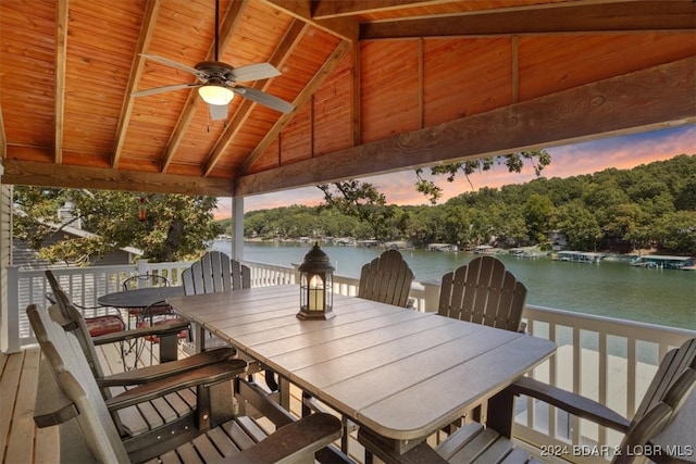 exterior space with ceiling fan, wooden ceiling, a water view, and lofted ceiling with beams