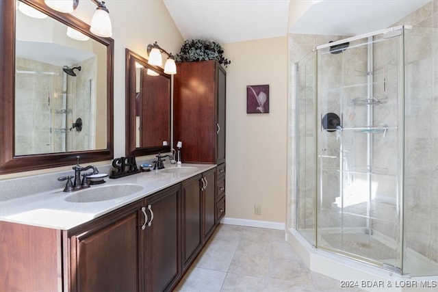 bathroom featuring tile patterned flooring, an enclosed shower, and vanity