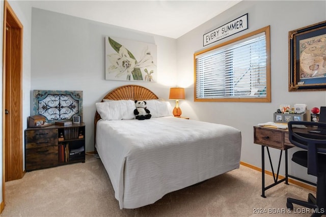 carpeted bedroom featuring baseboards