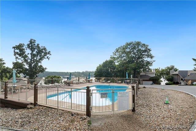 pool featuring a patio and fence