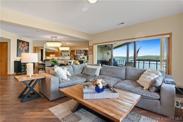 living room featuring hardwood / wood-style flooring and a notable chandelier