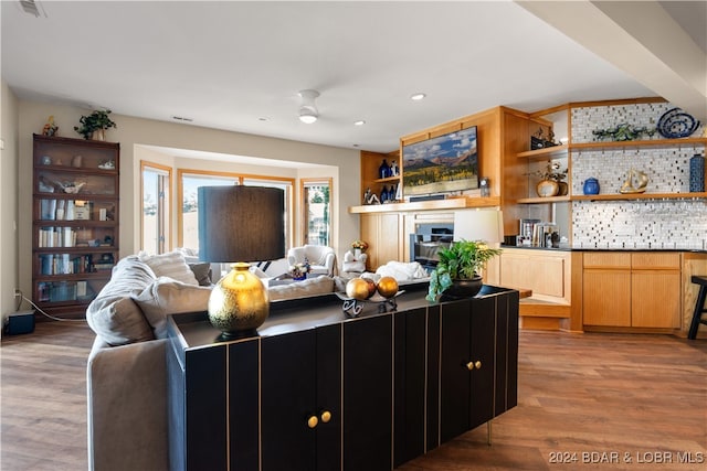 living room featuring ceiling fan and light hardwood / wood-style floors