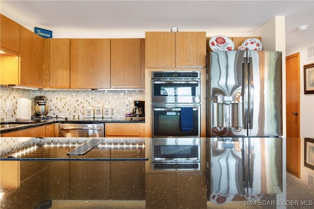 kitchen with stainless steel appliances and backsplash