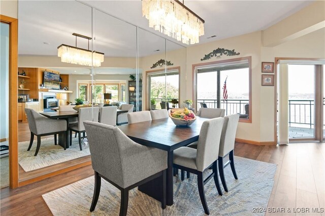 dining space with hardwood / wood-style floors and a chandelier