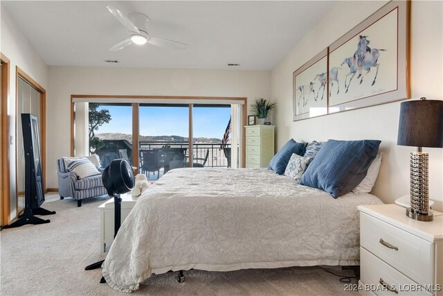 bedroom with light colored carpet, ceiling fan, and access to exterior