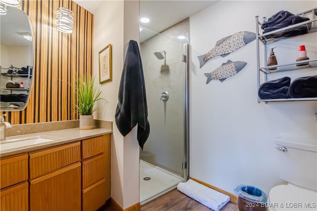 full bathroom with toilet, a stall shower, and vanity