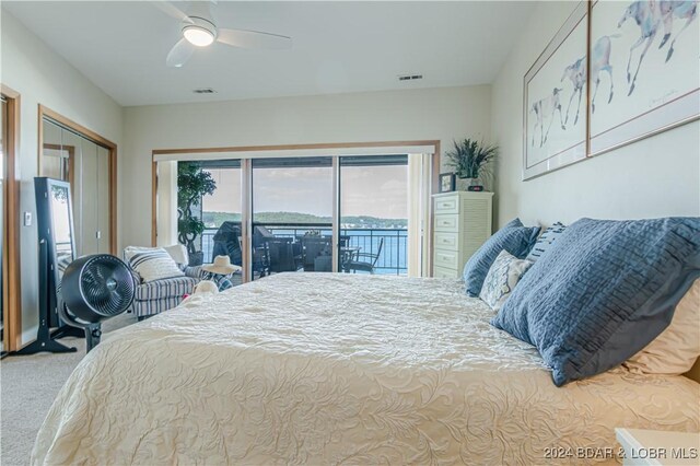 carpeted bedroom featuring a closet, ceiling fan, and access to outside