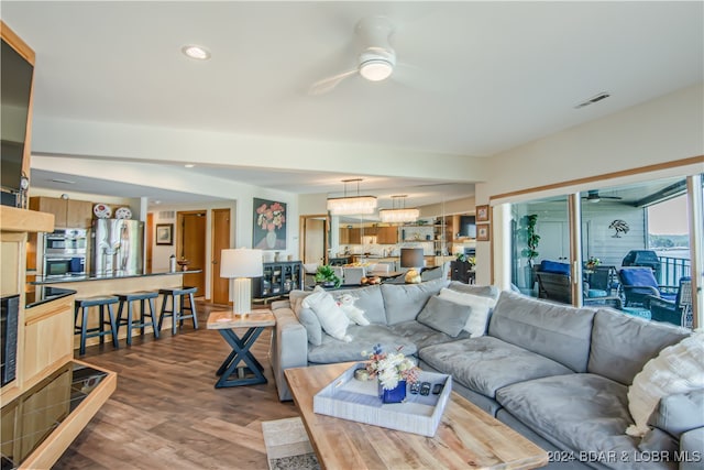 living room featuring hardwood / wood-style floors and ceiling fan