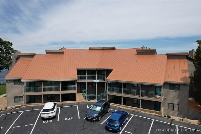 view of property featuring uncovered parking