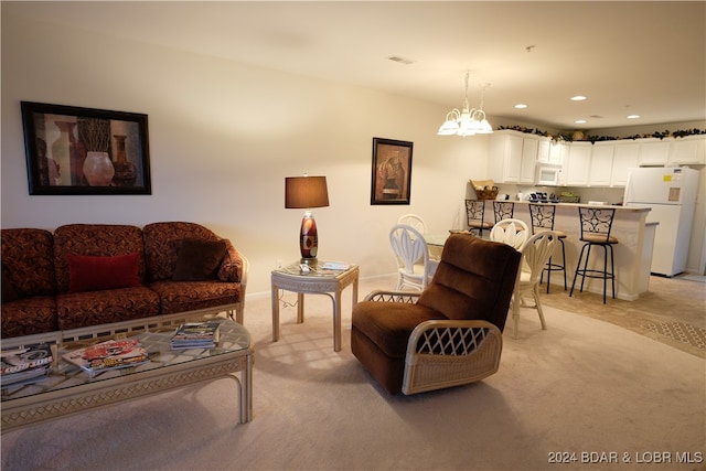 living room featuring light carpet and a chandelier