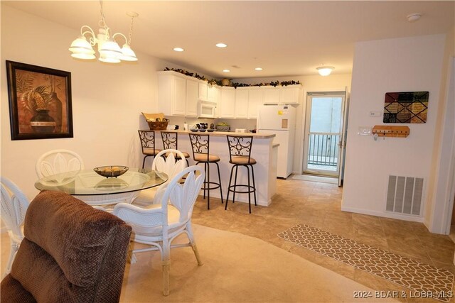 dining area featuring an inviting chandelier and light tile patterned floors