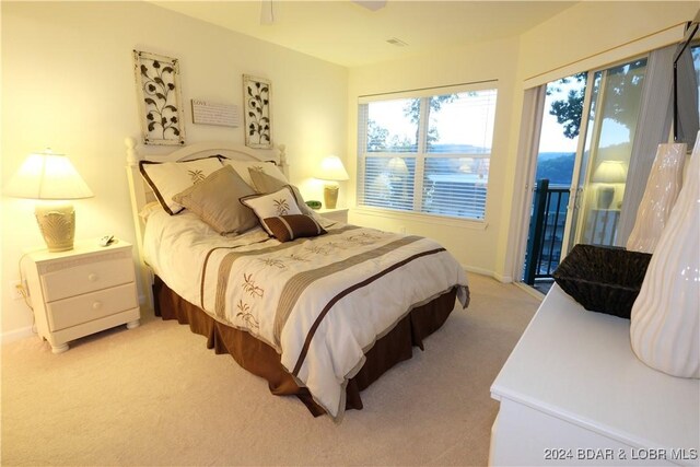 bedroom featuring access to outside and light colored carpet