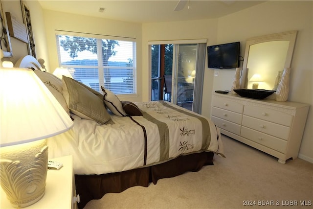 bedroom with access to exterior, visible vents, and light colored carpet