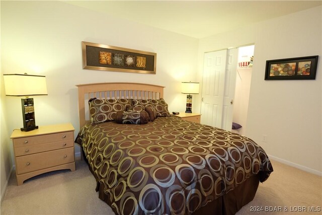 bedroom featuring a closet and light carpet