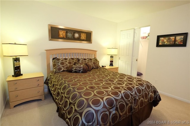 bedroom with light carpet and baseboards