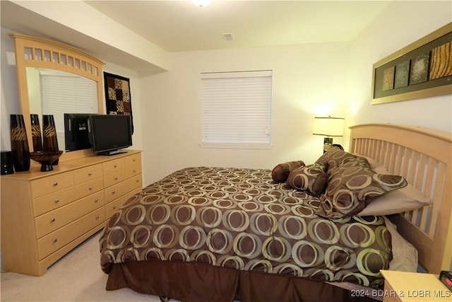 bedroom with light carpet and visible vents