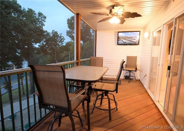 sunroom / solarium with wood ceiling and ceiling fan