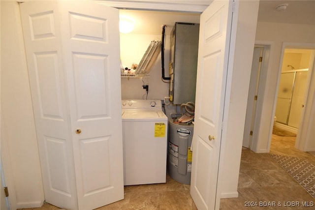 laundry area featuring washer / clothes dryer, water heater, and laundry area