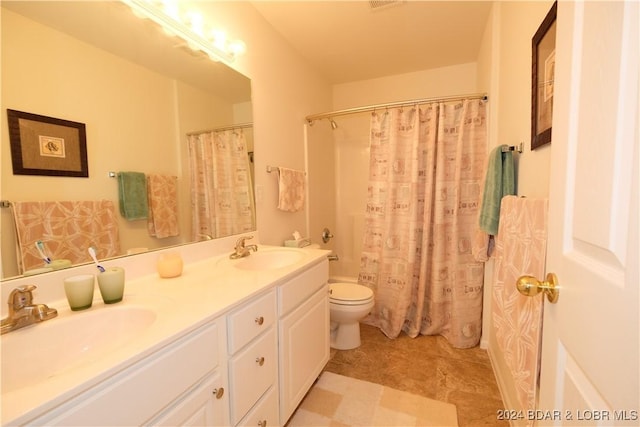 full bath with double vanity, shower / tub combo, a sink, and toilet