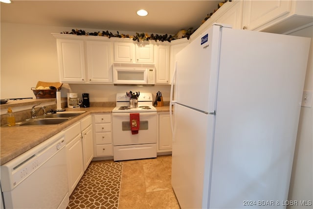 kitchen featuring white cabinetry, sink, and white appliances