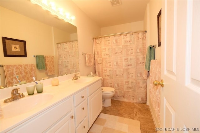 full bathroom with visible vents, a sink, toilet, and double vanity