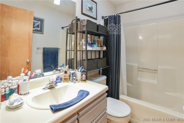 full bathroom with shower / bath combo, toilet, and vanity