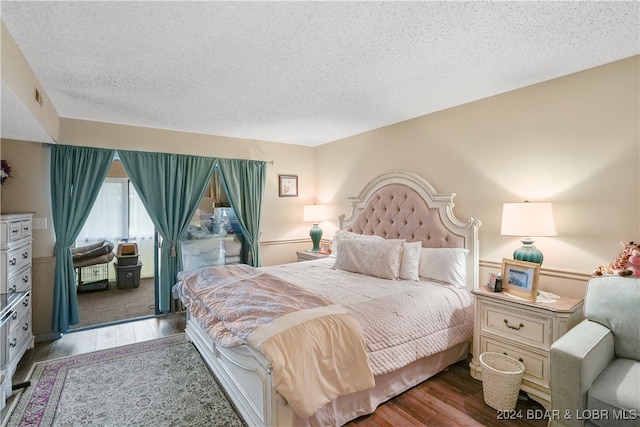 bedroom featuring a textured ceiling and light wood-type flooring