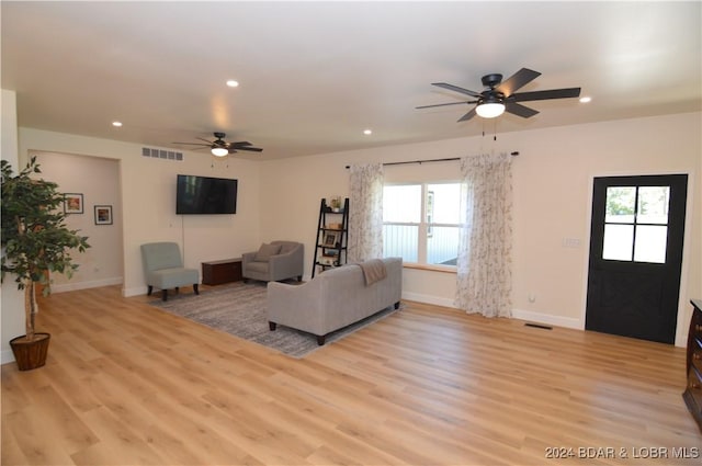 living room with ceiling fan and light wood-type flooring