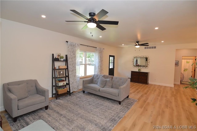 living room featuring ceiling fan and light wood-type flooring