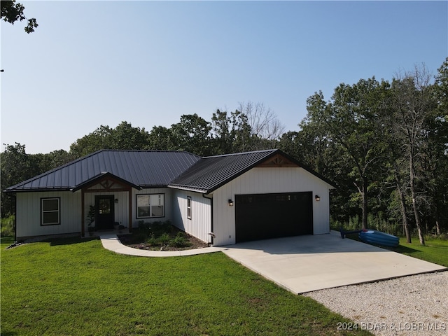 view of front of house with a garage and a front lawn