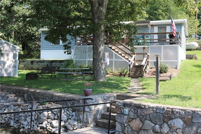 30193 Millcreek Loop, Gravois Mills, MO 65037 - view of grassy yard featuring stairway, a wooden deck, and a storage shed